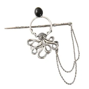 Detailed view of a vintage silver octopus hair pin with a black stone and double chain