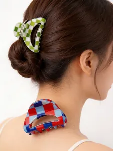 Detailed macro view of colorful checkerboard hair claw clips for trendy hair bun styling