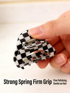 Detail showing the strong metal spring of the black and white checkerboard hair claw