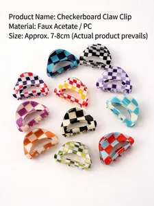 Detailed view of colorful checkerboard pattern hair claw clips in acetic acid material.