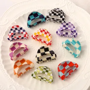 Close-up of colorful checkerboard mini acetate hair claw clips for versatile fashion styling