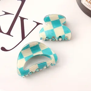 Detail of teal and white checkerboard small hair claw clips with smooth finish