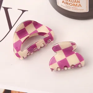 Detailed view of fashionable purple and beige checkered acetate hair claw clips for women