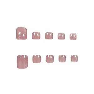 Detailed view of mauve cat-eye sparkly short square press-on toenails on white background