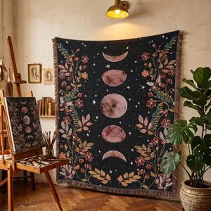 Bohemian woven blanket featuring moon phases and floral designs in an artist studio.