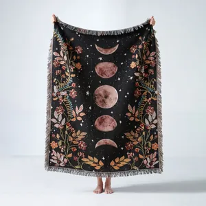 Bohemian woven throw blanket with vintage celestial moon phases and floral patterns