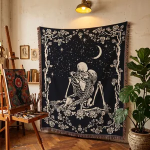 Artistic gothic woven blanket with skeleton and rose design displayed in a cozy studio