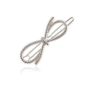 Close-up macro view of silver twisted rope infinity design hair clip with elegant reflection
