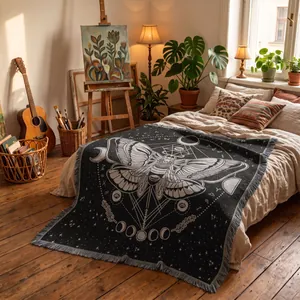Decorative bohemian woven moth throw blanket with moon phases displayed on a cozy bed