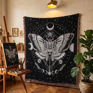 Woven moth tapestry with celestial moon phases displayed in an art studio setting