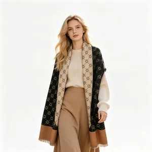 Close-up of elegant thick imitation cashmere scarf with monogram pattern on model.
