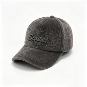 Detailed macro view of gray furry baseball cap with 'Sweet' rhinestone letter decoration