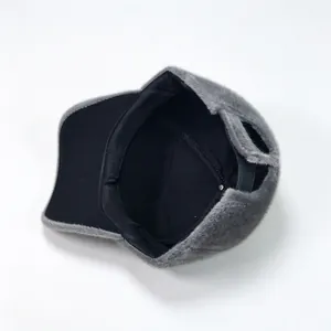 Detail view of plush grey winter baseball cap showing soft black fabric inner lining.