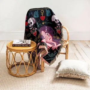 Artistic Bohemian woven throw blanket with fringe draped on a rattan chair