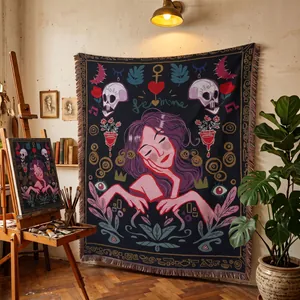 Bohemian woven tapestry blanket with artistic female portrait and skull motifs in studio.