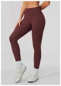 Detail view of maroon high-waisted yoga leggings with soft brushed fabric and flattering fit