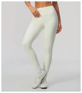 High-waisted cream yoga leggings with peach butt lift design and brushed fabric.
