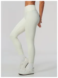 Side view of cream high-waisted butt lifting yoga leggings shown with athletic footwear