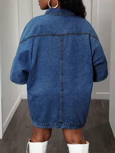 Back view detail of oversized sleeveless denim jacket with classic blue wash and raw seams.