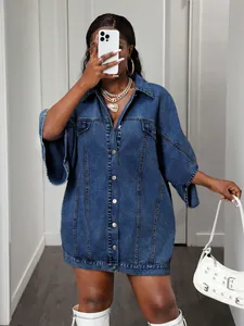 Detail of oversized denim shirt dress with loose cape sleeves and silver buttons