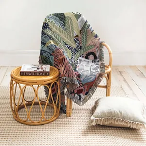 Detailed view of woven throw blanket with tiger and jungle leaf design on a chair