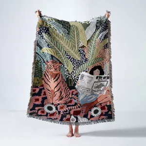Large woven artistic throw blanket with tiger and tropical leaves design and fringe