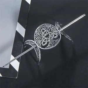 Detailed view of silver-toned alloy hairpin with Celtic tree and moon motifs.