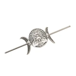 Close-up of vintage silver alloy hair pin with hollow Celtic knot and crescent moon motifs