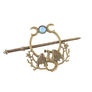 Detailed view of vintage bronze hair pin with flying dragon, moon, and tree branch motifs.