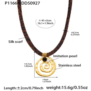 Detailed view of leopard print silk scarf necklace with golden spiral pendant and labels