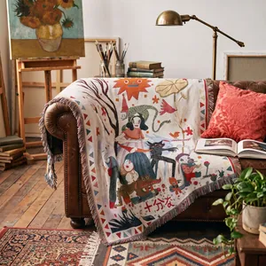 Artistic bohemian woven throw blanket with fringe detail on a leather sofa