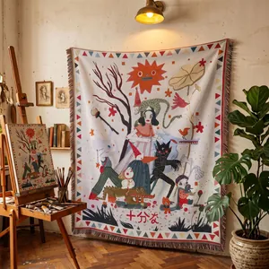 Bohemian style woven tapestry blanket with fringe edges displayed in an artist studio