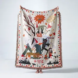 Detailed macro view of the intricate Bohemian woven pattern and fringed edges of the blanket.