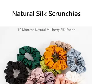 Close-up of assorted 19 momme mulberry silk scrunchies showing fabric texture and luster.