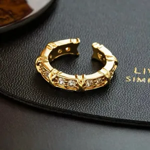 Macro view showing the intricate zircon inlay and cross design on a gold-plated ring