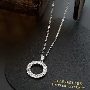 Detailed macro view of a silver circular pendant necklace encrusted with sparkling zircon stones