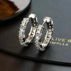 Elegant silver-tone bamboo style hoop earrings with shimmering round cubic zirconia stones