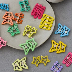 Detailed shot of various colorful star and butterfly-shaped BB hair clips on cards