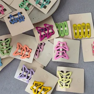 Detail showing variety of colorful butterfly and star hair clips for kids on cards