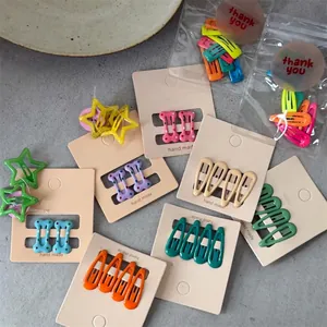 Detailed view of colorful assorted star bone and drop hair clips for kids on backing cards