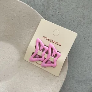 Pink butterfly-shaped BB hair clips on a handmade accessories card.