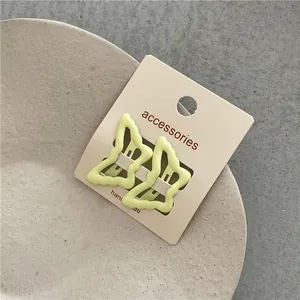 Elegant pair of light green butterfly-shaped BB hair clips for girls on display card