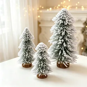 Three snow-flocked cedar Christmas trees with wooden bases for holiday tabletop decoration