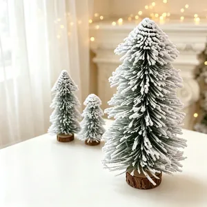 Miniature flocked cedar Christmas trees with wooden bases for festive desktop decor.