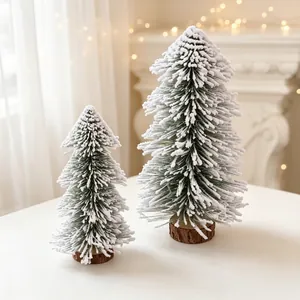 Detailed view of two mini flocked cedar Christmas trees with natural wooden bases.