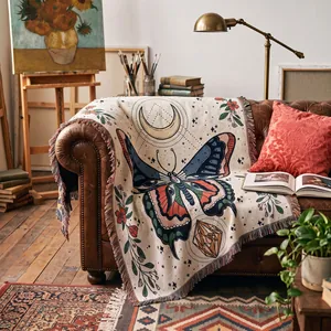 Macro detail of bohemian woven butterfly throw blanket displayed on a classic leather sofa.
