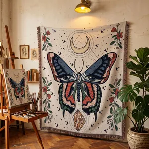 Bohemian woven throw blanket featuring a mystical butterfly design in an art studio