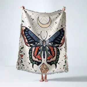 Bohemian woven fringed throw blanket featuring a mystical butterfly and moon motif