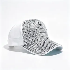 Dettaglio ravvicinato degli strass argentati scintillanti su un cappellino da baseball bianco.