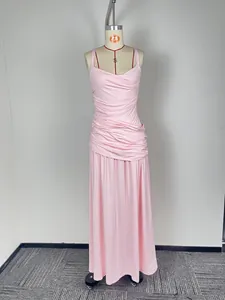 A full-length view of a pink ruched sleeveless maxi dress displayed on a mannequin.